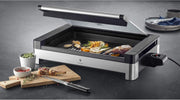 Parrilla de mesa eléctrica WMF Lono con tapa de cristal, placa de grill revestida, bandeja de goteo extraíble, apta para lavavajillas, acero inoxidable mate, 2200 vatios