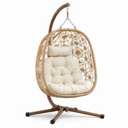 Sillón colgante de ratán con estructura de acero y cojín de poliéster color crema
