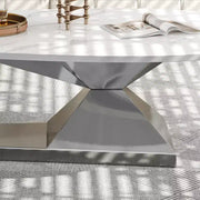 Mesa de centro con superficie de cerámica y base contemporánea de acero inoxidable, una pieza elegante y duradera para la sala de estar.
