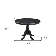 Mesa de comedor HomeRoots 42 con base de pedestal de madera sólida y madera manufacturada redondeada en color negro