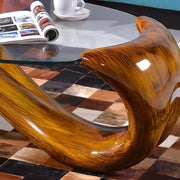 Mesa de centro abstracta moderna con base de metal y cubierta de cristal ovalada