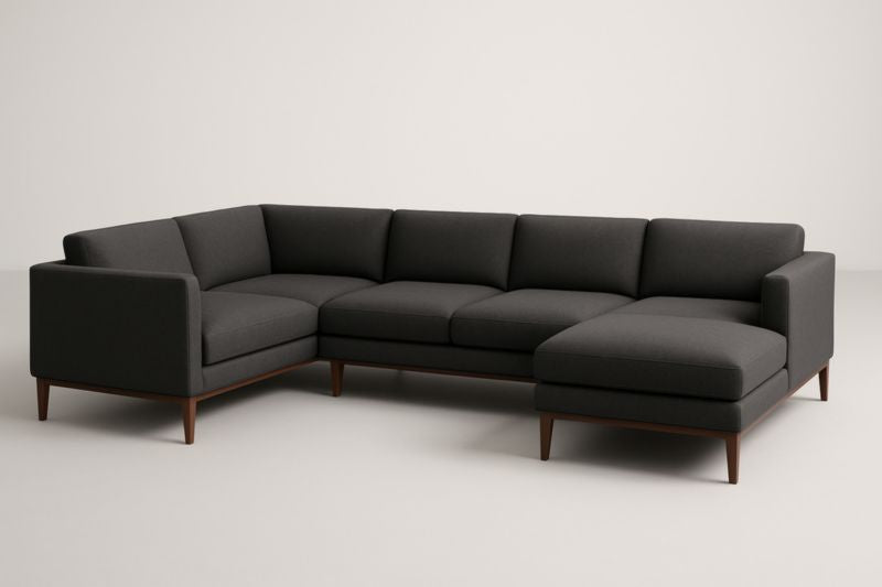 Sofá rinconero de tela gris oscuro con patas de madera