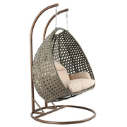 LeisureMod Silla Colgante Huevo para 2 Personas con Soporte - Columpio Hamaca Lounger de Ratán para Patio Exterior/Interior con Cojines